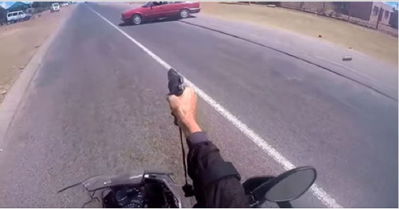 NO FEAR policeman on a bike takes down suspects in a car